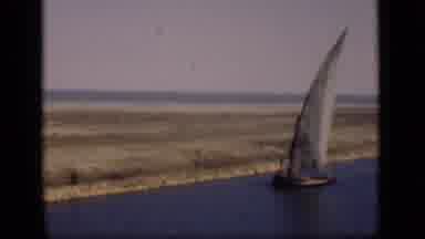 Suez Canal Egypt (1946): A Sailboat Gently Sails Across A Calm Water Area Along