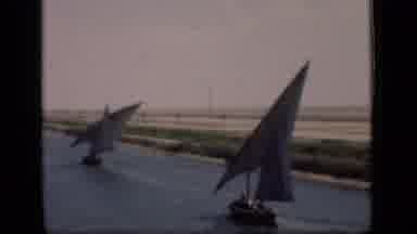 Suez Canal Egypt (1946): Pair Of Blue Sailboats In Water On A Sunny Day