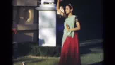 India (1947): Woman Wearing Red And Green Dress Performs Folk Dance On A Sunny Day