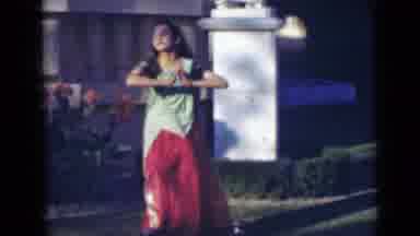 India (1947): A Girl Dressed Up Like A Genie Dancing Around Outside With A Bottle