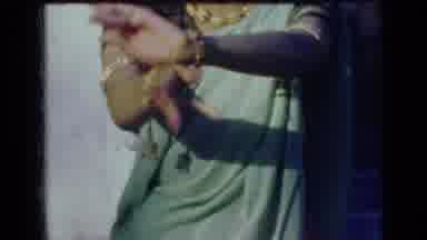 India (1947): Woman Wearing Green Sari Performs Hand Gestures On A Sunny Day