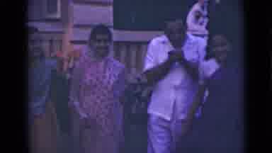 India (1947): Man Walking With Three Women While Lighting A Cigar When One Of The