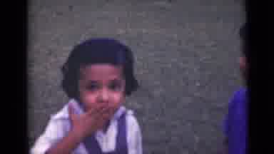 India (1947): Two Kids Standing Around When One Blows A Kiss To The Camera Then A