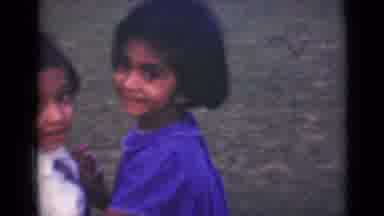 India (1947): A Young Boy And Girl Dance Together Outside On A Sunny Day
