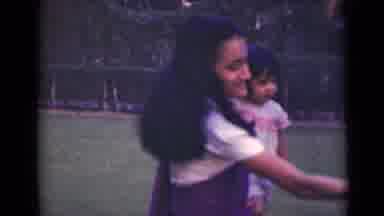 India (1947): Girl Holding Baby While Tugging On Someone In Front Of Church