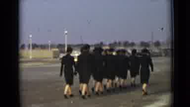 New York-1947: Group Of Women Wearing Black Uniforms Marching In Synchronization