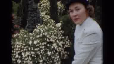 New York (1947): Woman In White Uniform And White Hat Next To Flower Bush Looks At
