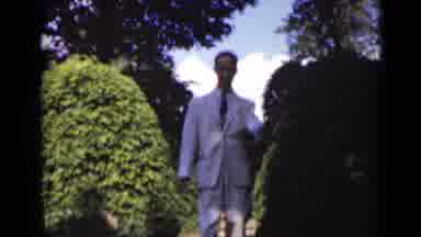New York (1947): A Man In White Formal Attire Walks Slowly Down A Stairway Flanked