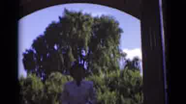 New York (1947): A Woman In White Dress In Walking In Front Of Building Gate