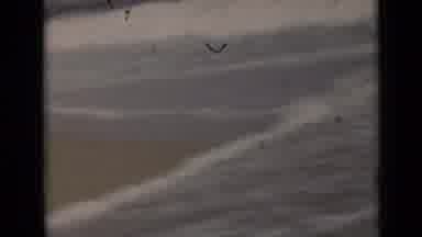 New York (1947): Two Women Walk Barefoot Along The Shore While Waves Crash At