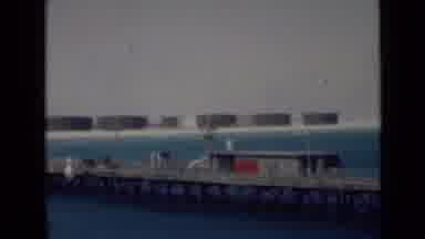 Persian Gulf (1947): View Of A Body Of Water With A Pier And Tackle Shop