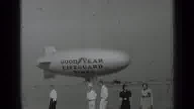 San Francisco California-1937: People Walking Near Goodyear Blimp