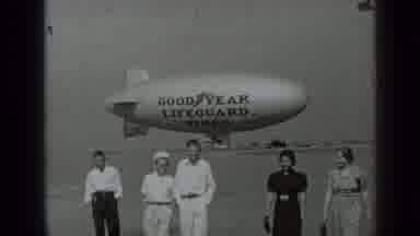 San Francisco California-1937: Five People Walking Near Goodyear Blimp
