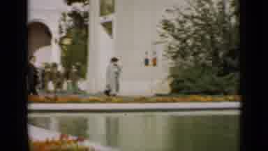 San Francisco California (1937): People Walking In A Garden Of A Building With A
