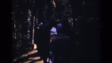 Colorado USA (1938): Dozen People Walking On Dirt Road In Poorly Lit Dry Forest In