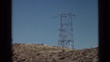 Arizona USA (1939): A Car Drives Down An Empty Road In The Desert With A Pylon On