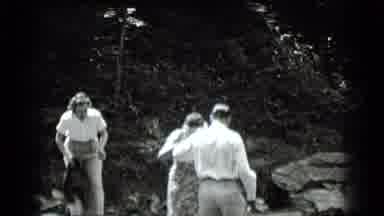 Clear Lake California (1939): Man Helps A Woman To Cross A River In The