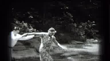 Clear Lake California (1939): Man Helping A Lady In A Dress Cross Over A Stream Of