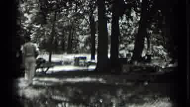 Clear Lake California (1939): A Scene Of Three People Walking In The Woods Outside
