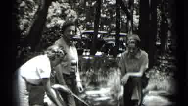 Clear Lake California (1939): Three People Are Roasting Marshmallows Over A