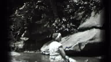 Clear Lake California (1939): Woman Sitting While Other Women Walks By