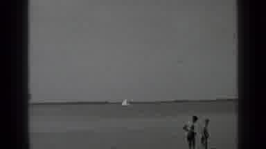 Clear Lake California (1939): People On The Beach Watch The Boat Sailing Across