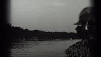 CLEAR LAKE CALIFORNIA-1939: A Woman Smiles At The Camera Followed By A Man In A