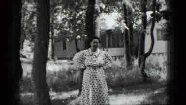 Clear Lake California (1939): Woman In Polka-Dot Dress In Front Of House In Woods