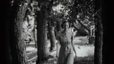Clear Lake California (1939): Woman Walking In White Dress Through The Trees In