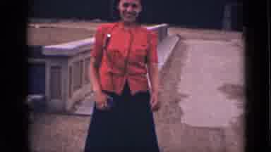 Colorado USA (1939): Woman In Red Walking On The Street And Mountains And Trees
