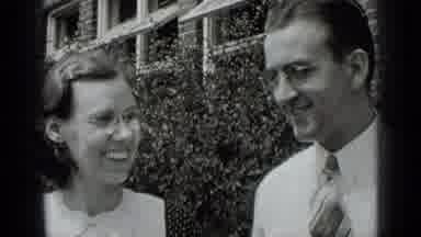 New York USA (1939): Man And Woman Standing In Front Of Some Bushes Smiling And