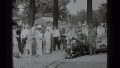 New York USA (1939): A Small Train Ride Passes A Crowd Of People With A Conductor