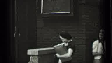 New York USA (1939): Two Men In Suits And Tie Shake Hands As A Woman In A White