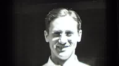 New York USA (1939): Young Man With Glasses Who Looks Very Happy Raises His