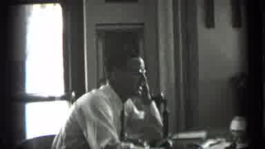 New York USA (1939): Man Smiles At The Camera Then Talks On The An Antique Phone