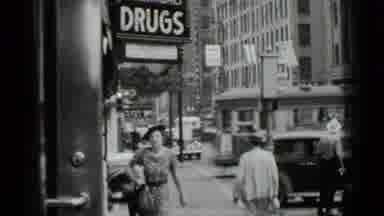 New York USA (1939): Woman On Busy Street Walking Past Drug Store