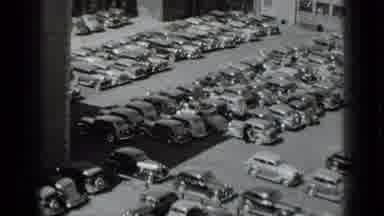 New York USA (1939): Car Pulling Out Of Parking Spot In A Yard Of Vehicles Being