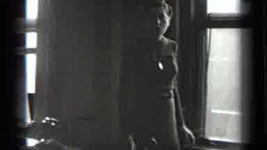 New York USA (1939): Woman In Dress And Necklace In Window With Hair Up Turning