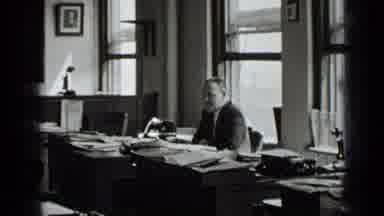 New York USA (1939): Man Talking To Women Filing Papers In Workplace