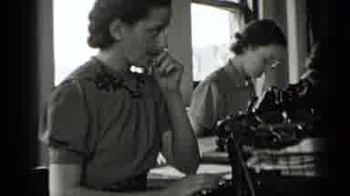 New York USA (1939): Woman Scratches Her Nose As Other Around Her Work And Outside