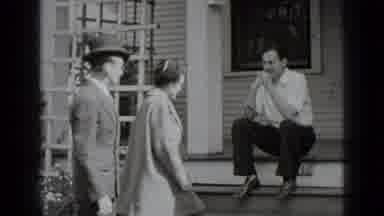New York USA (1939): Man And Woman Walk Up The Steps And Stand Next To The Man