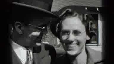 New York USA (1939): Happy Couple Smiles In Front Of Camera Followed By Moving