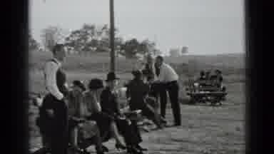 New York USA (1939): Group Of People Sitting On A Bench On A Bright Sunny Day