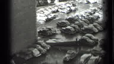 NEW YORK USA-1939: Man Walking Up Stairs To House With Classic Cars In Parking Lot