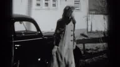 New York USA (1939): Woman Exiting Car Throws Keys Towards Front Door Of House