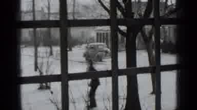 New York USA (1939): Woman Ice Skates In Front Of A House While There Is Snow All