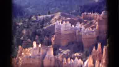 Utah USA (1939): Landscape With Orange Pointy Rocks And A Mountain Full Of Trees