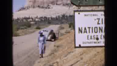 Utah USA (1939): A Woman Walking Up A Small Hill In A Desert Turns Around
