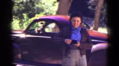 Utah USA (1939): An Elderly Woman Adjusts Herself In Front Of A Red Car On A Very