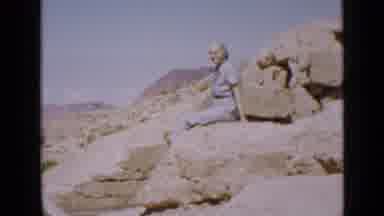 Utah USA (1939): Woman Sits On Large Rocks And Soaks Up The Sun And Takes In The